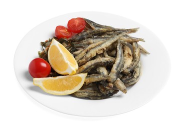 Photo of Plate with delicious fried anchovies, cherry tomatoes and slices of lemon isolated on white