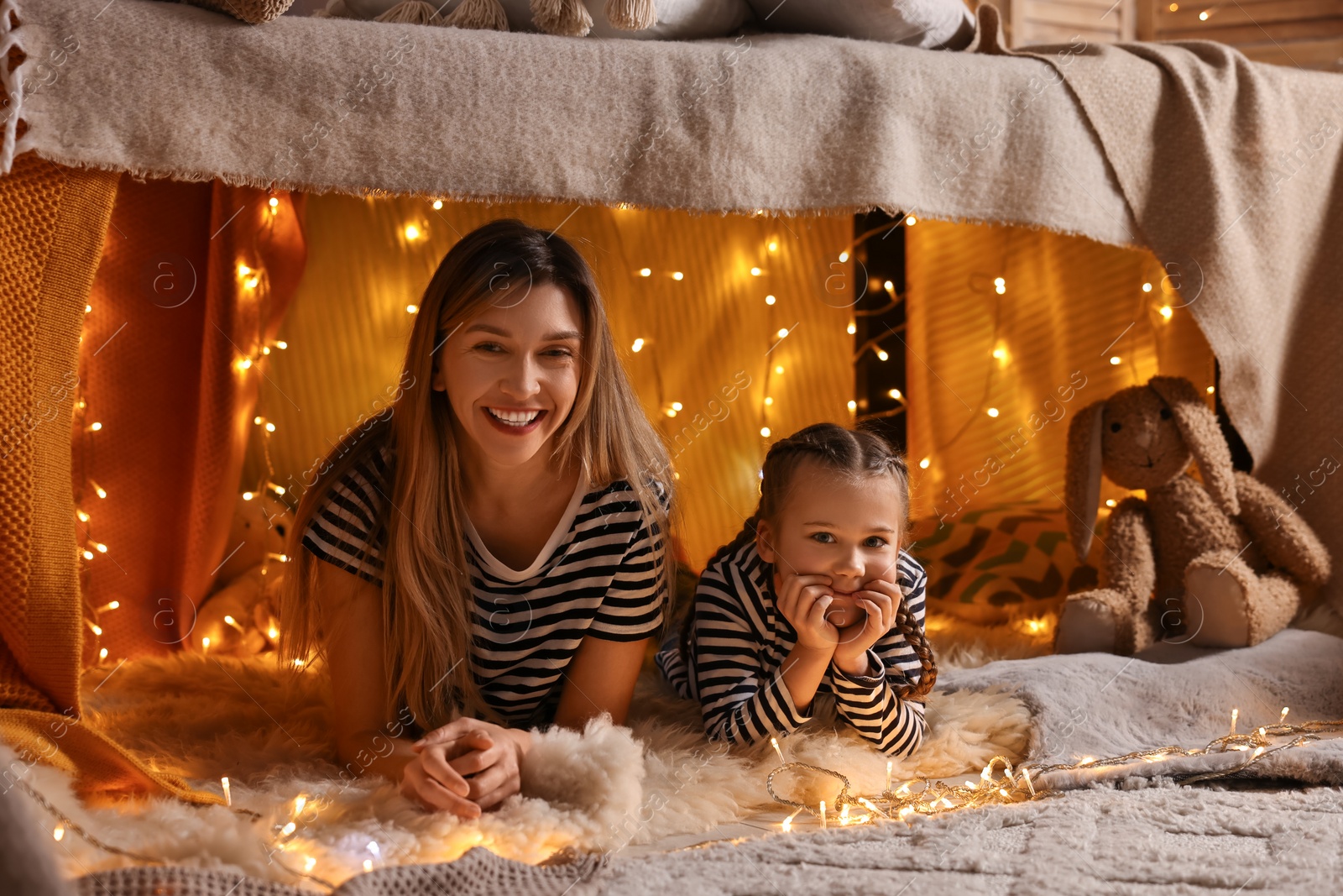 Photo of Mother and her daughter in play tent at home