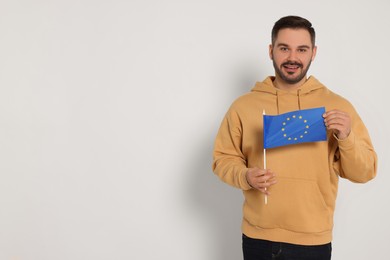 Man with flag of European Union on white background, space for text