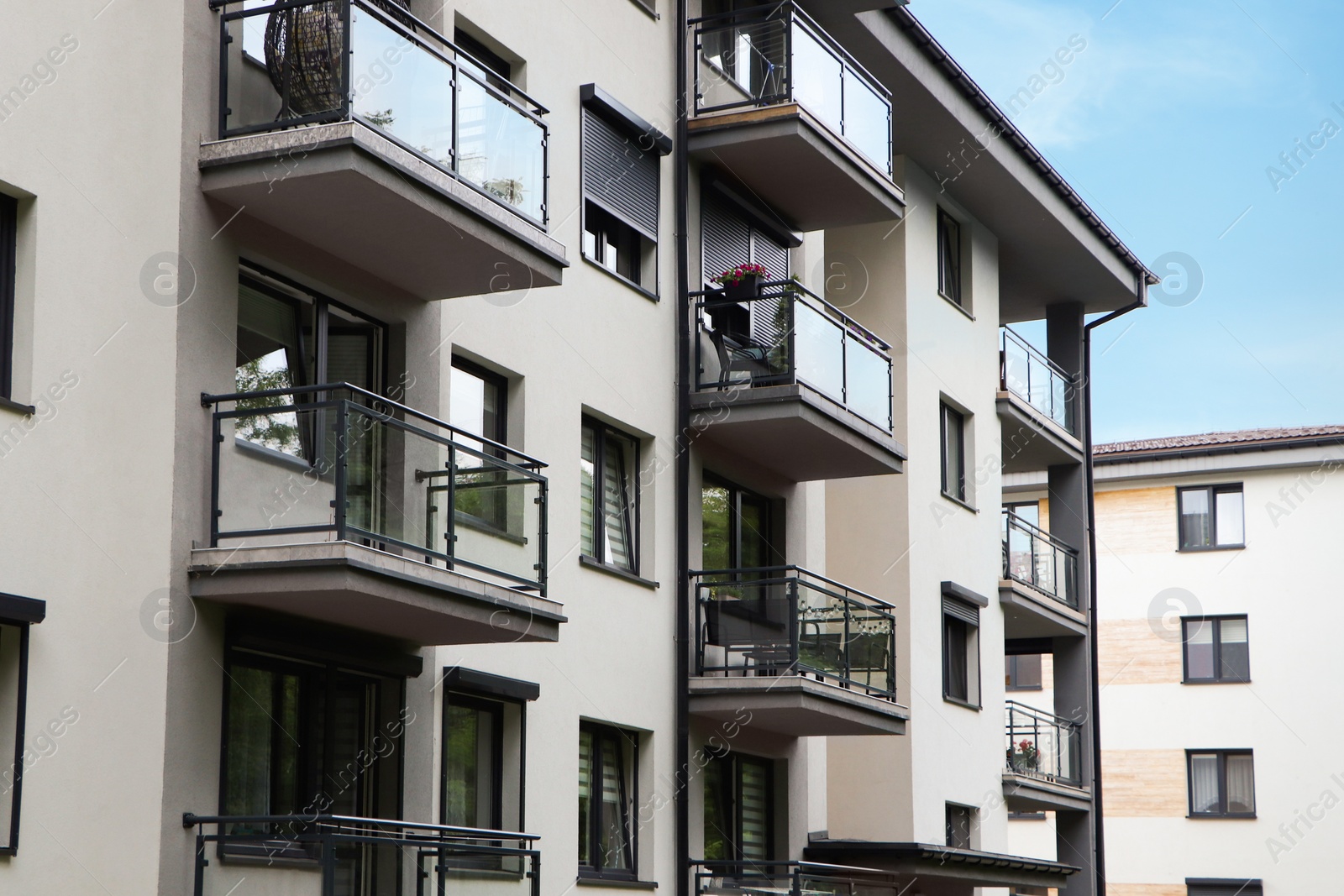 Photo of Exterior of white and black building with glass balconies