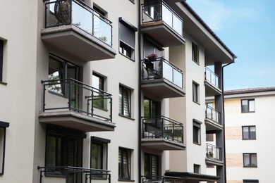 Exterior of white and black building with glass balconies