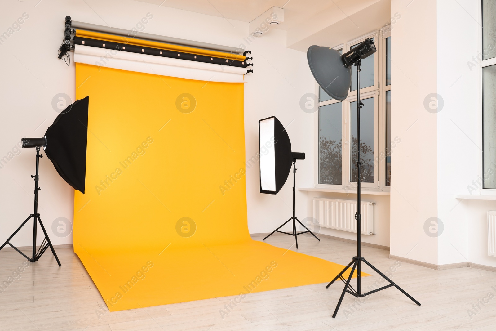 Photo of Interior of modern photo studio with professional lighting equipment