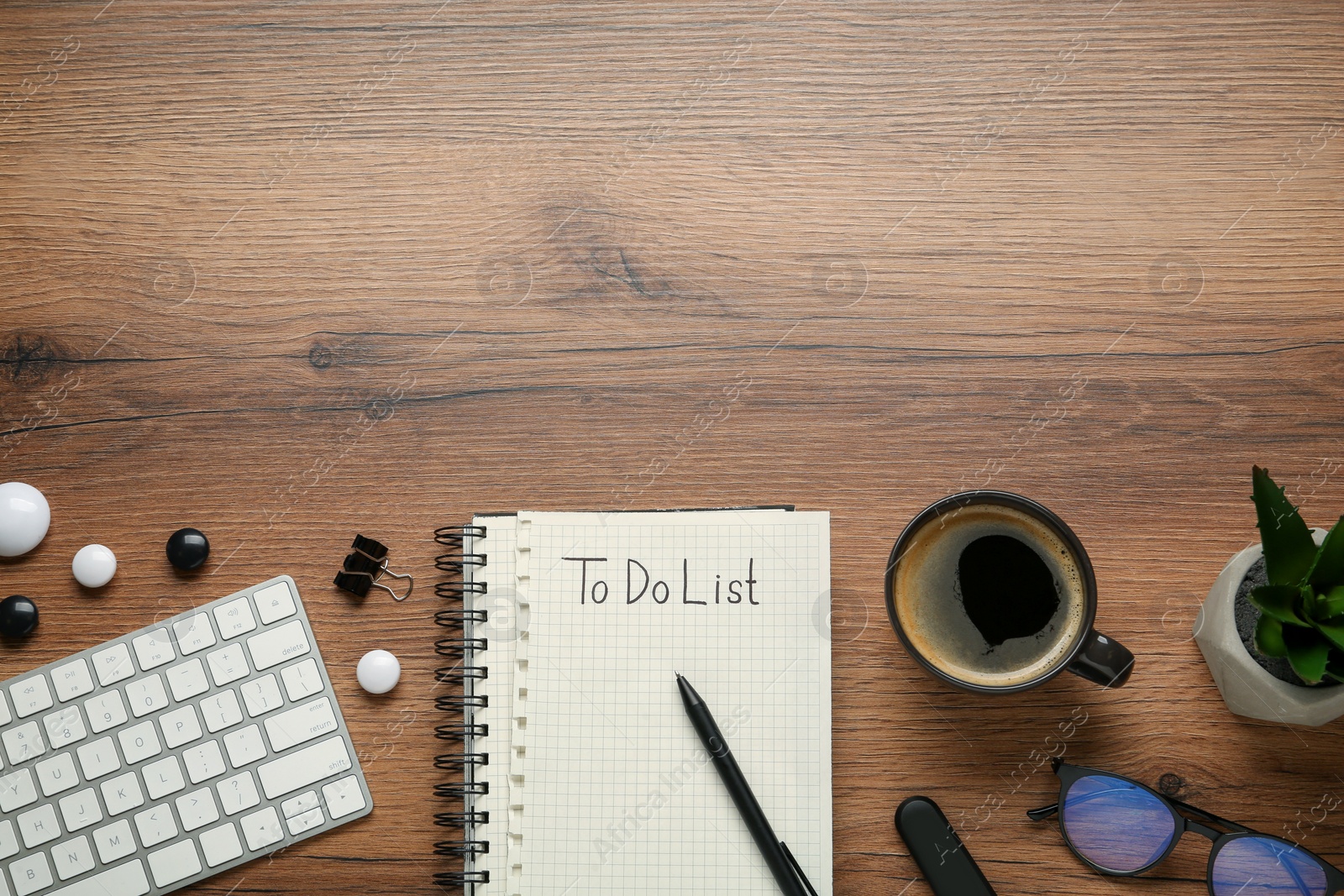 Photo of Flat lay composition with unfilled To Do list, cup of coffee and computer keyboard on wooden table, space for text