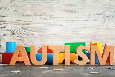 Word "Autism" and building blocks on table