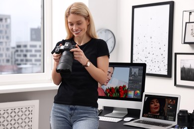 Professional photographer with modern digital camera in office