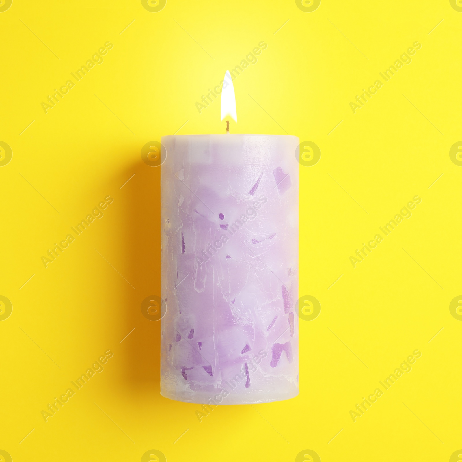 Photo of Alight scented wax candle on color background