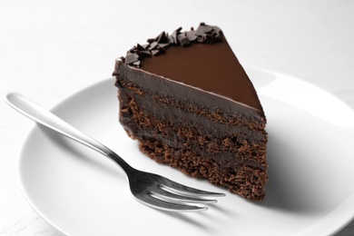 Photo of Delicious fresh chocolate cake served on white table, closeup