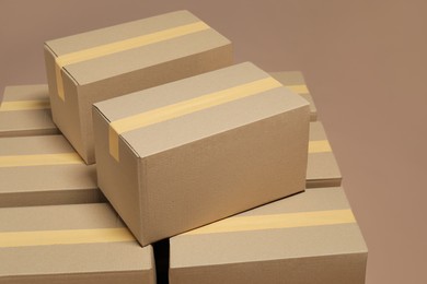 Photo of Many cardboard boxes on light brown background