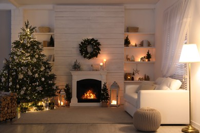 Stylish living room interior with decorated Christmas tree and comfortable sofa