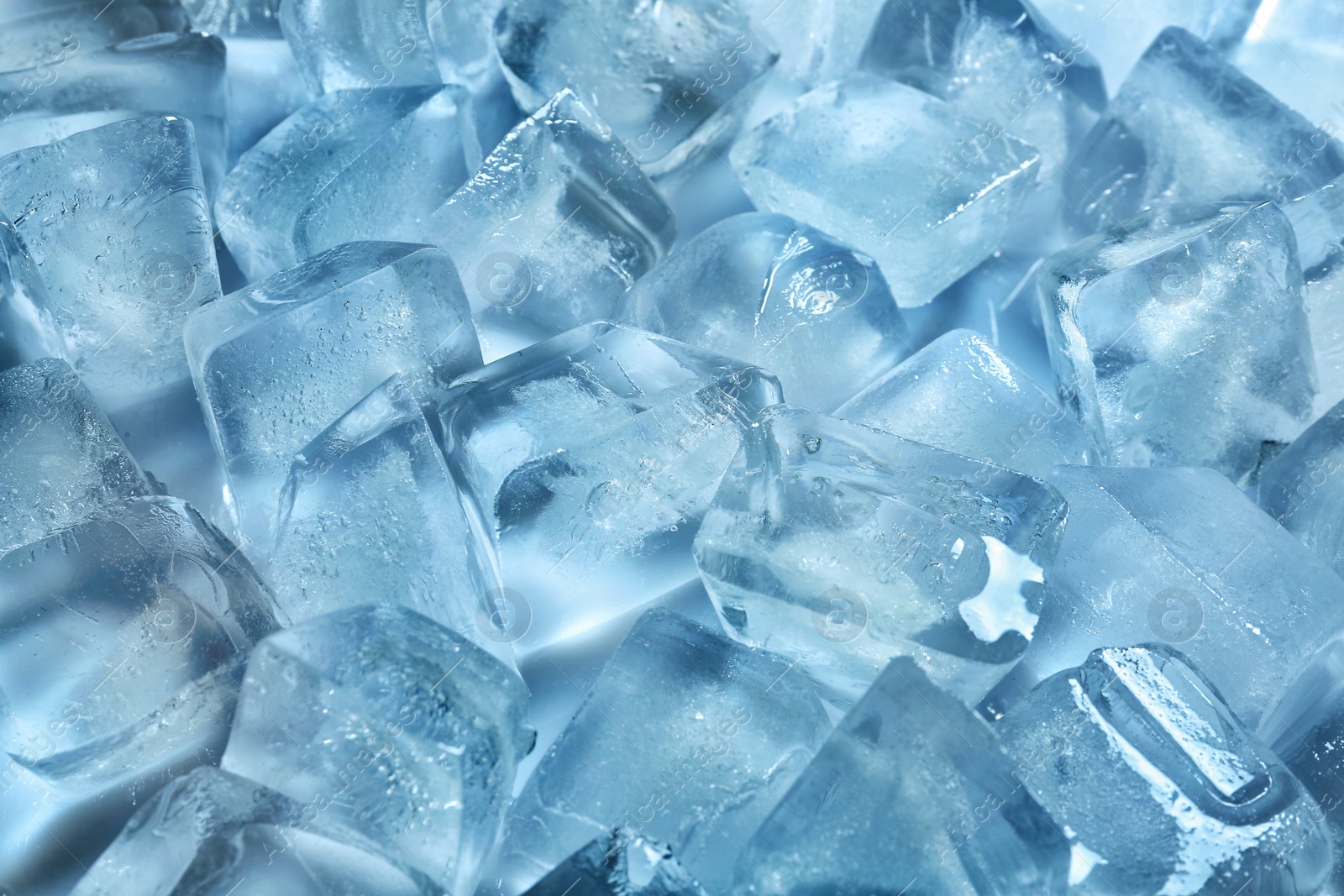 Photo of Pile of ice cubes on color background
