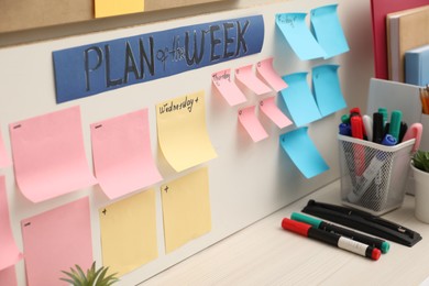 Business process planning and optimization. Workplace with colorful paper notes and other stationery on table, closeup