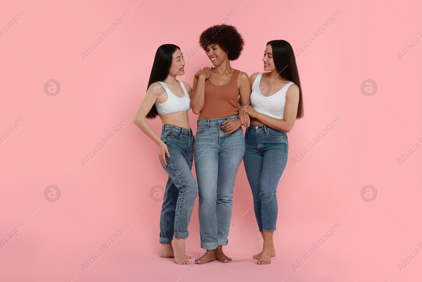 Photo of Portrait of beautiful young women on pink background