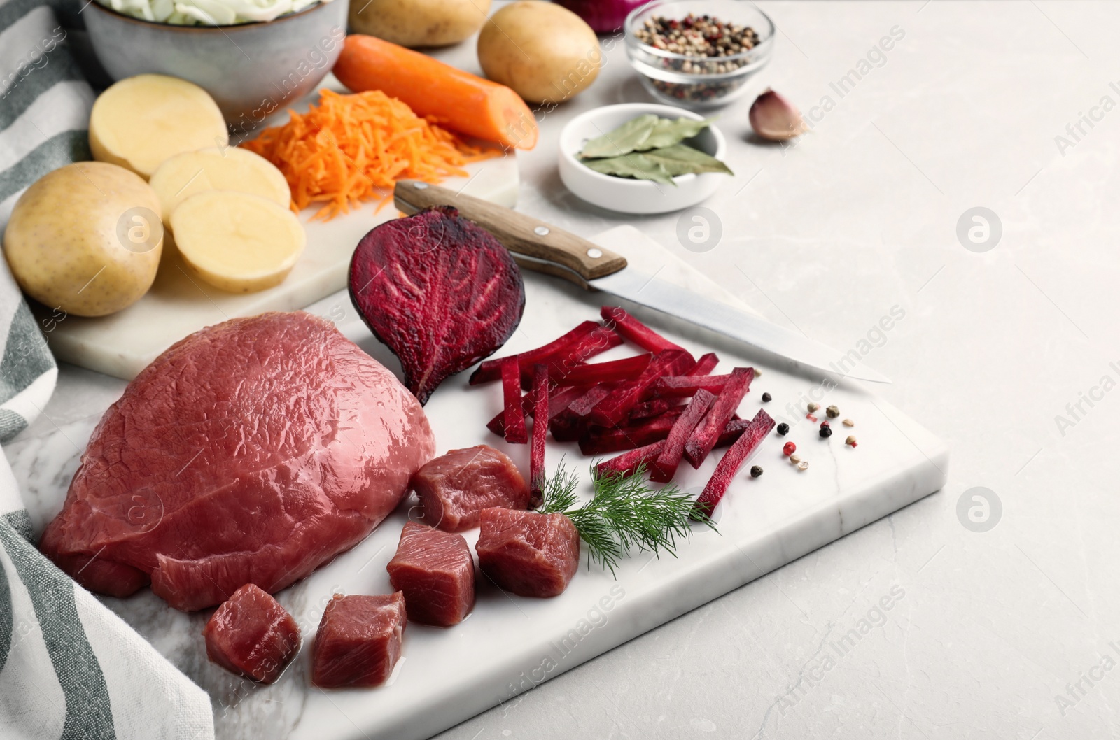 Photo of Fresh ingredients for borscht on light grey table