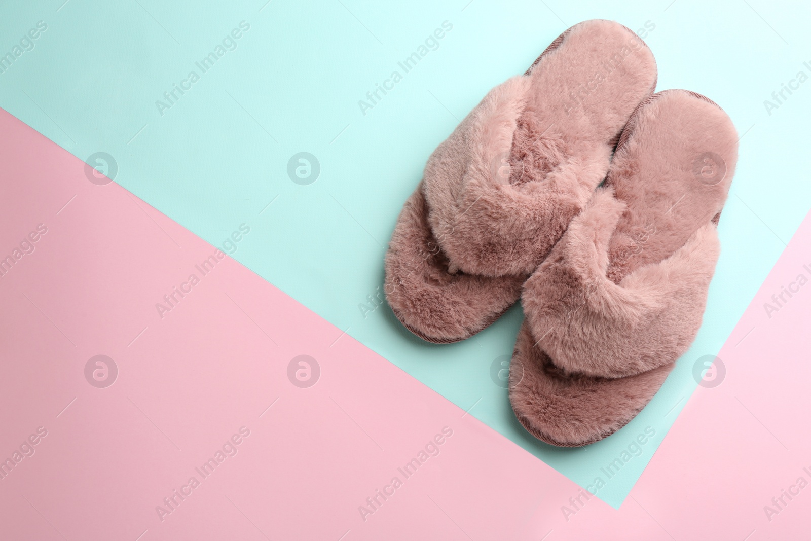 Photo of Pair of stylish soft slippers on color background, flat lay. Space for text