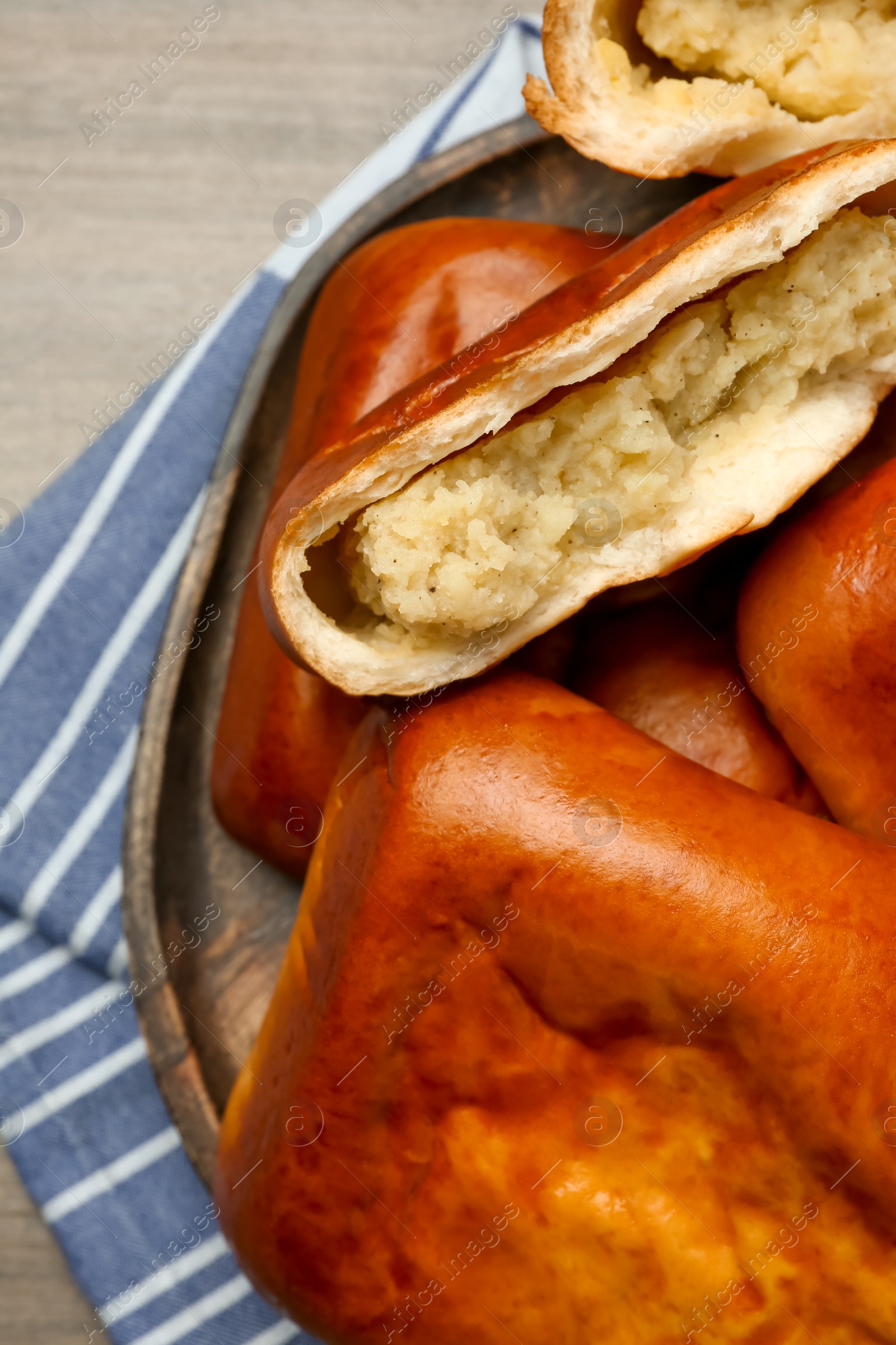 Photo of Delicious baked patties with potato on wooden table, top view