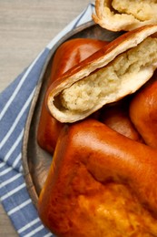 Delicious baked patties with potato on wooden table, top view