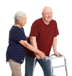 Photo of Elderly woman helping her husband with walking frame on white background