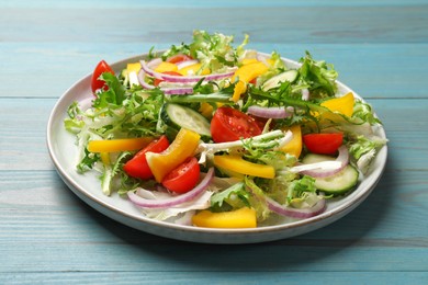 Tasty fresh vegetarian salad on light blue wooden table, closeup