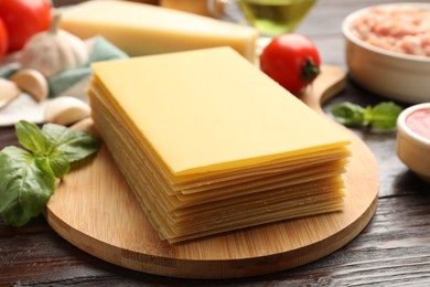 Photo of Ingredients for lasagna on wooden table, closeup