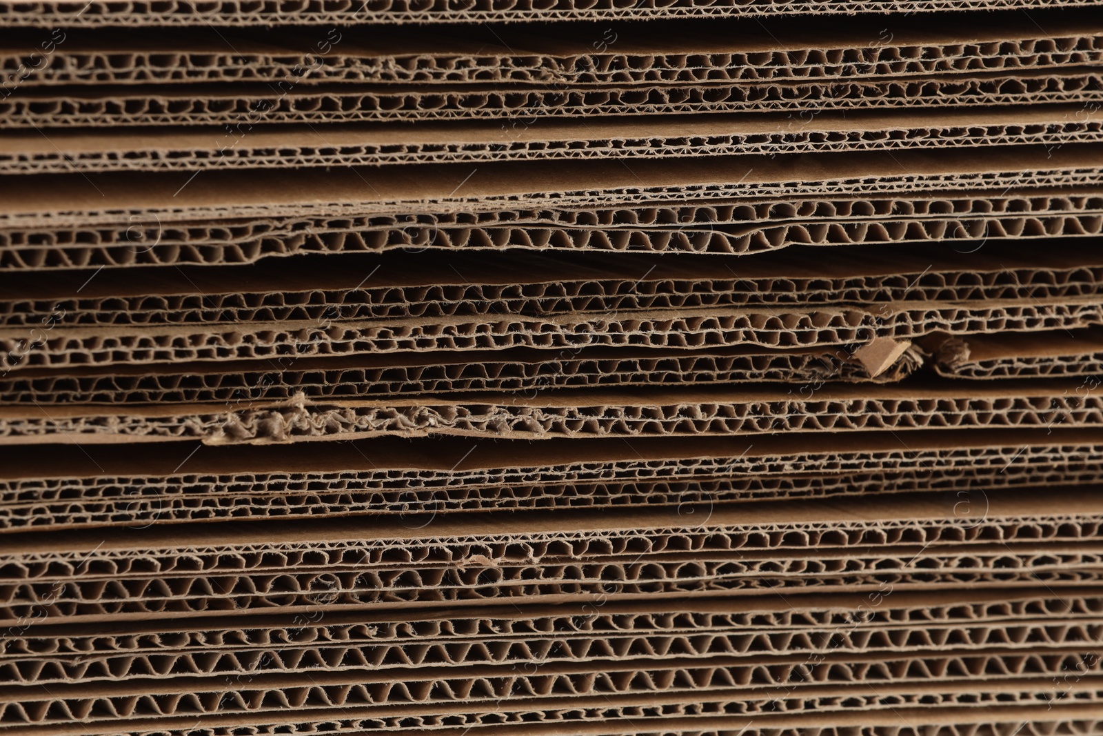 Photo of Sheets of brown corrugated cardboard as background, closeup