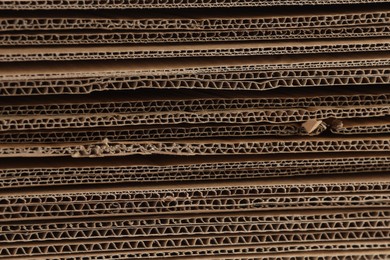 Photo of Sheets of brown corrugated cardboard as background, closeup