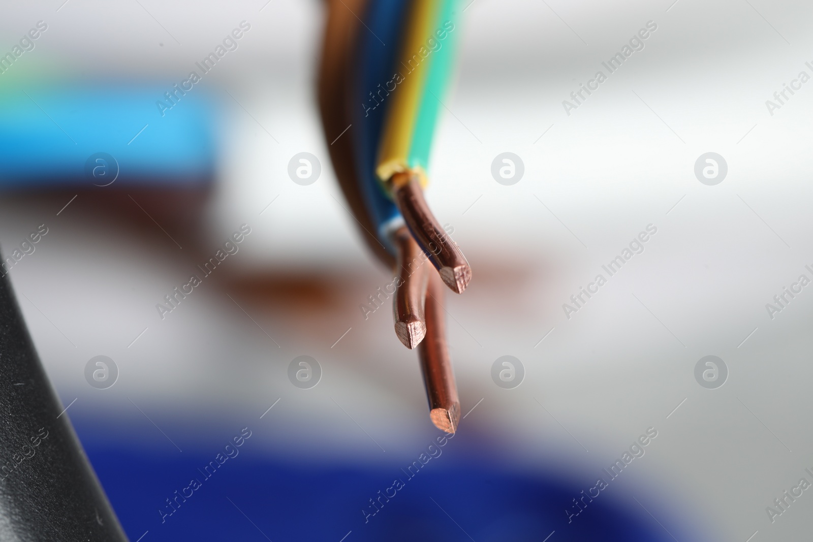 Photo of Colorful electrical wire on blurred background, closeup