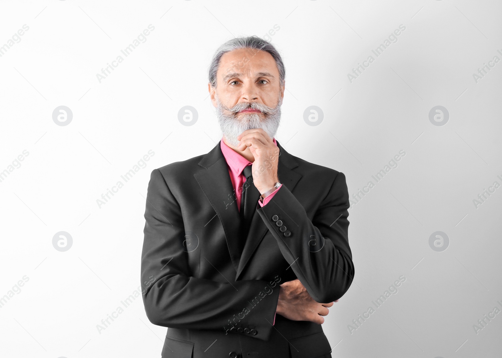 Photo of Handsome bearded mature man in suit on white background