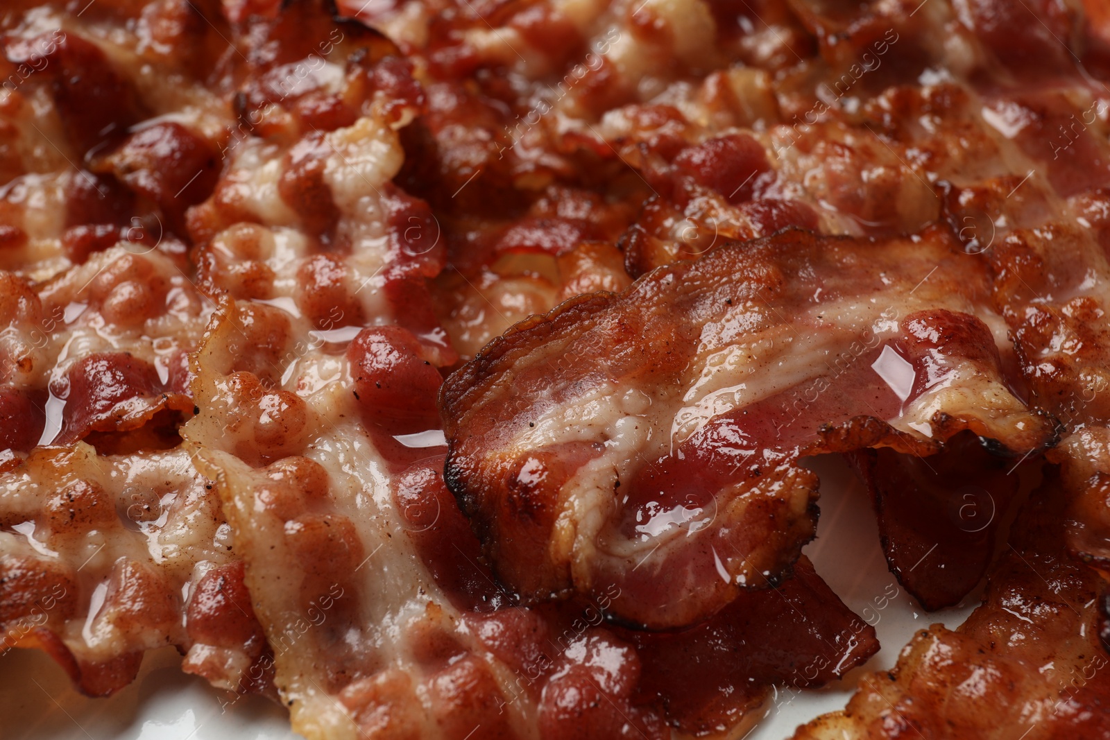 Photo of Slices of tasty fried bacon as background, closeup