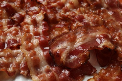 Photo of Slices of tasty fried bacon as background, closeup