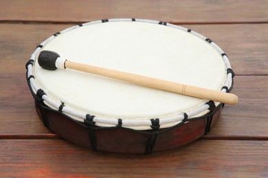 Modern drum with drumstick on wooden table. Percussion musical instrument