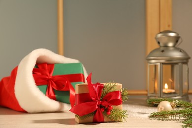 Photo of Gift boxes and festive decor on window sill indoors. Christmas eve