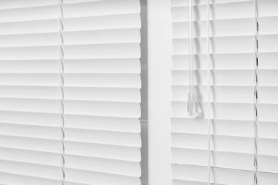 Photo of Window with closed white horizontal blinds as background