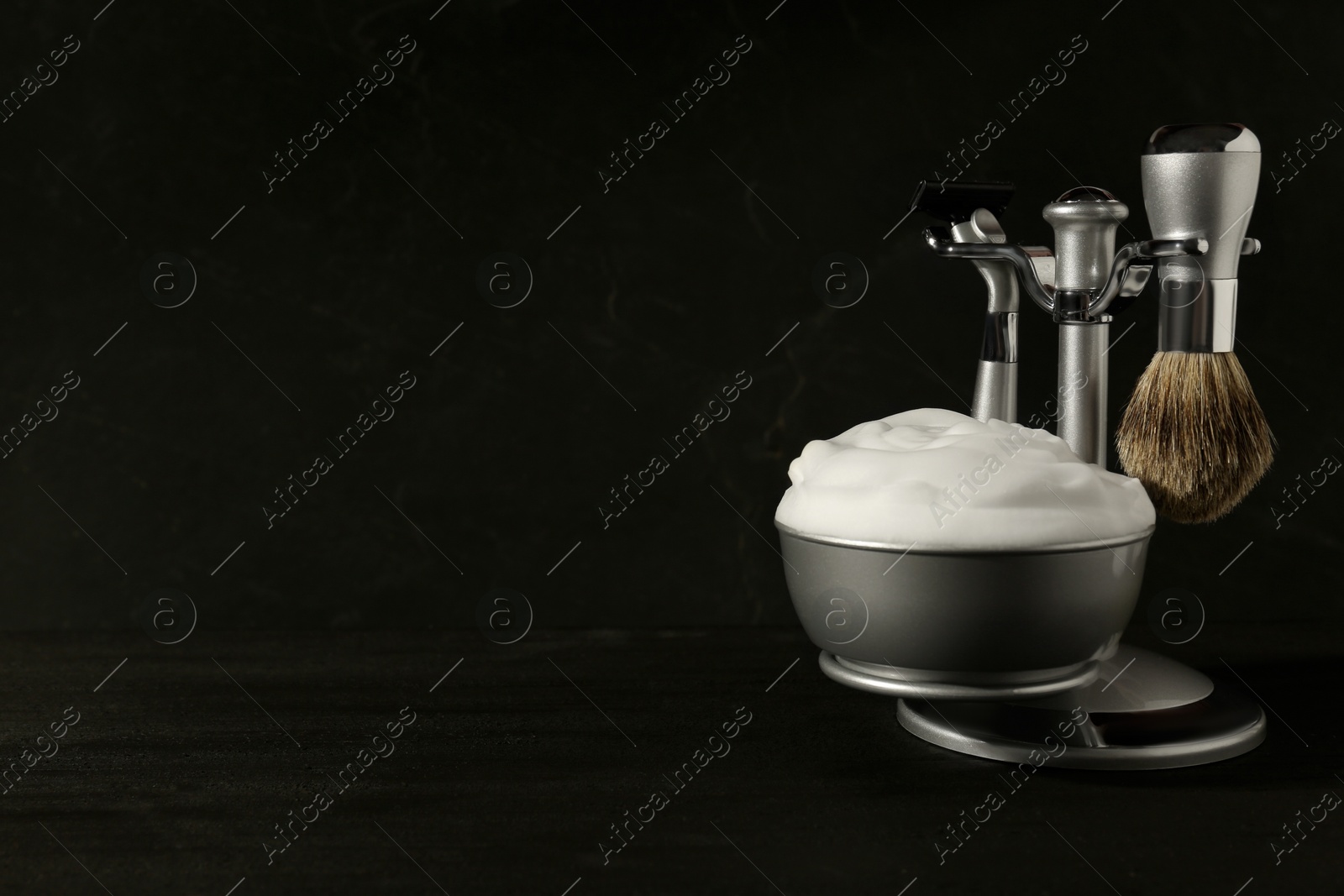 Photo of Set of men's shaving tools and foam on black background, space for text