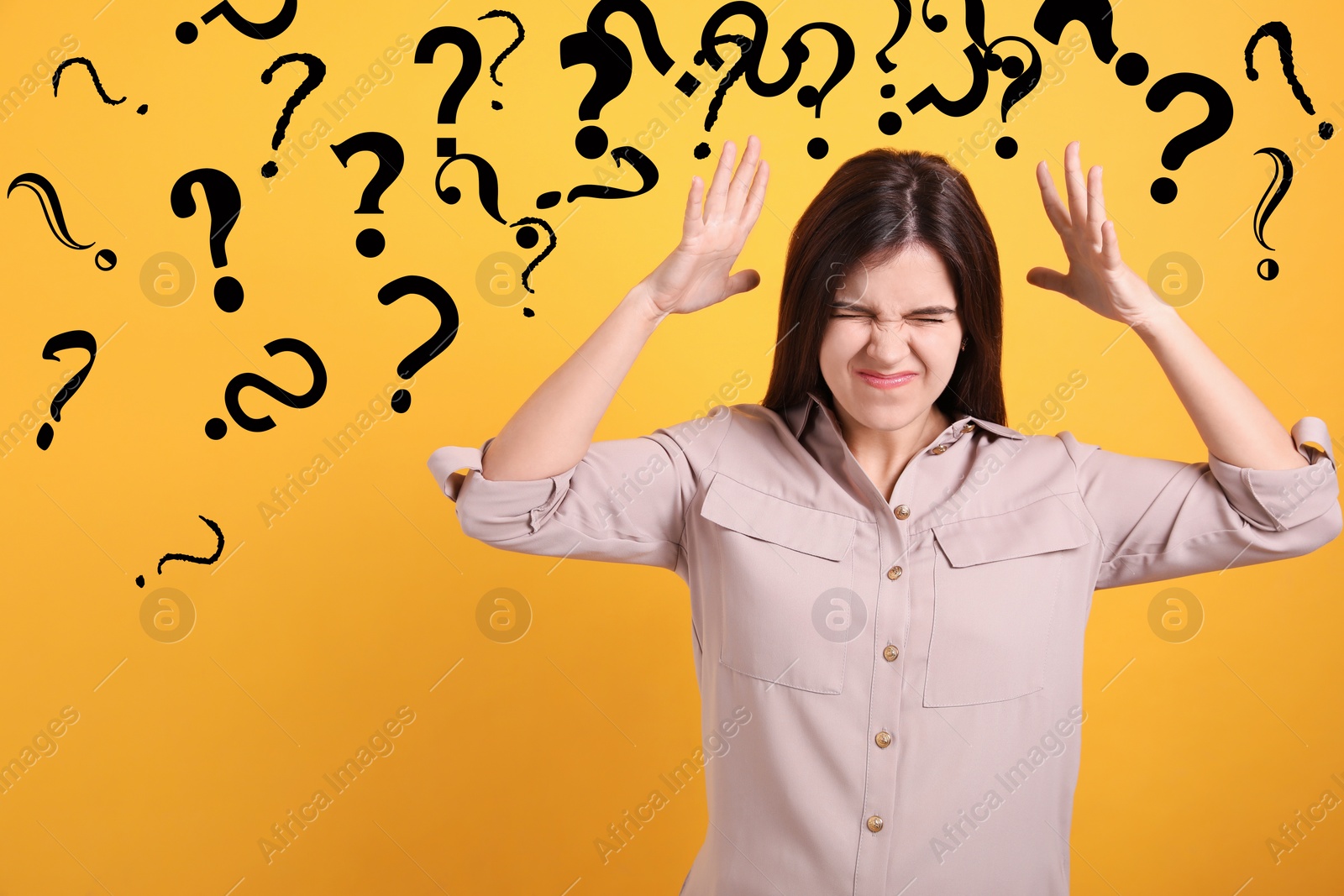 Image of Amnesia. Confused young woman and question marks on yellow background