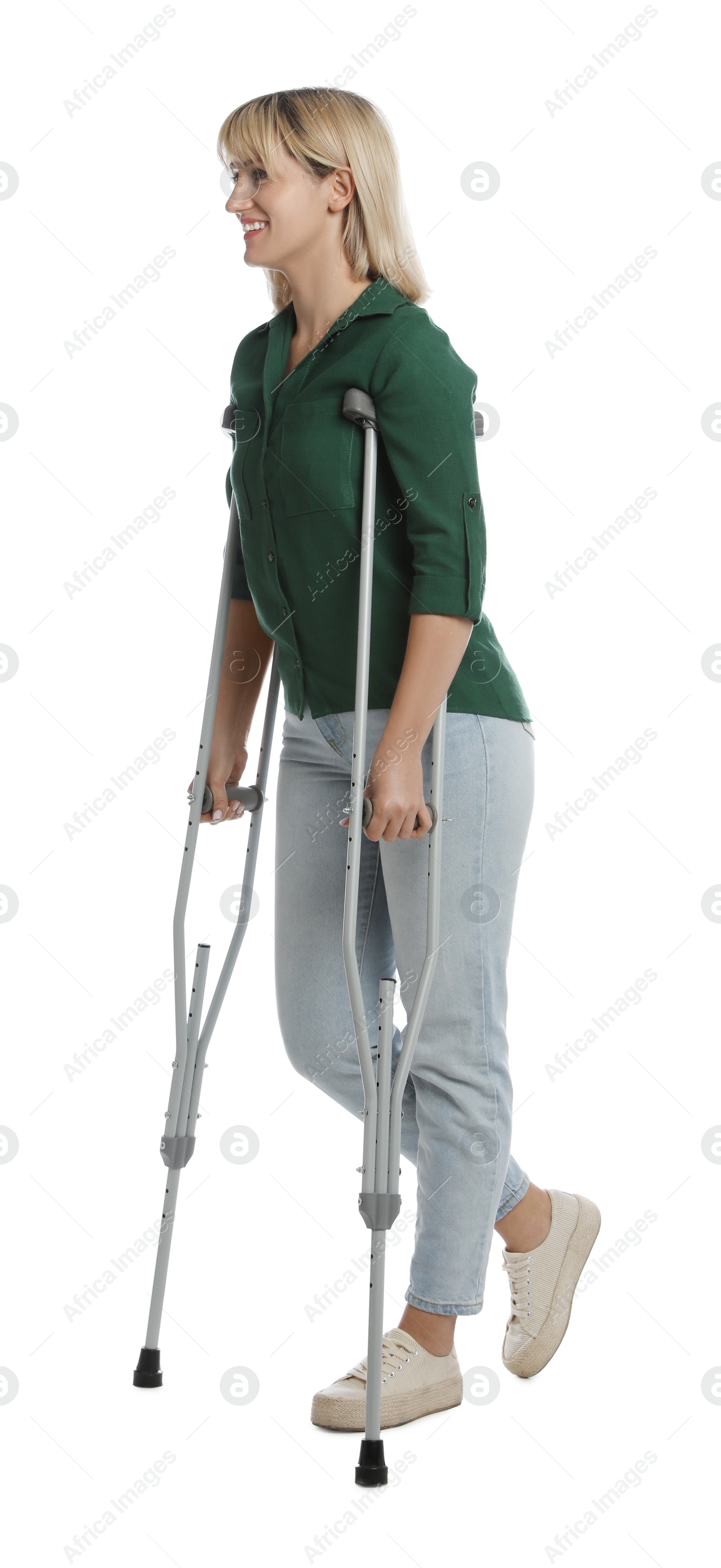 Photo of Full length portrait of woman with crutches on white background