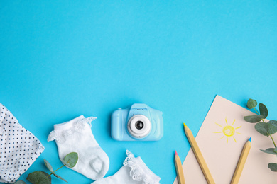 Photo of Flat lay composition with toy camera on light blue background, space for text. Future photographer