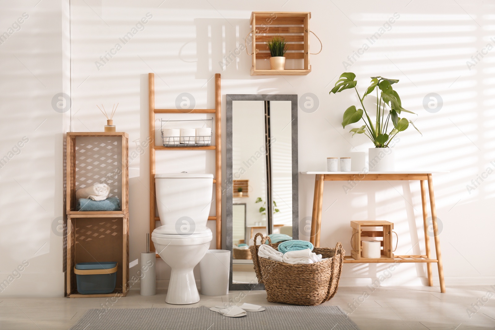 Photo of Interior of stylish bathroom with toilet bowl and decor elements