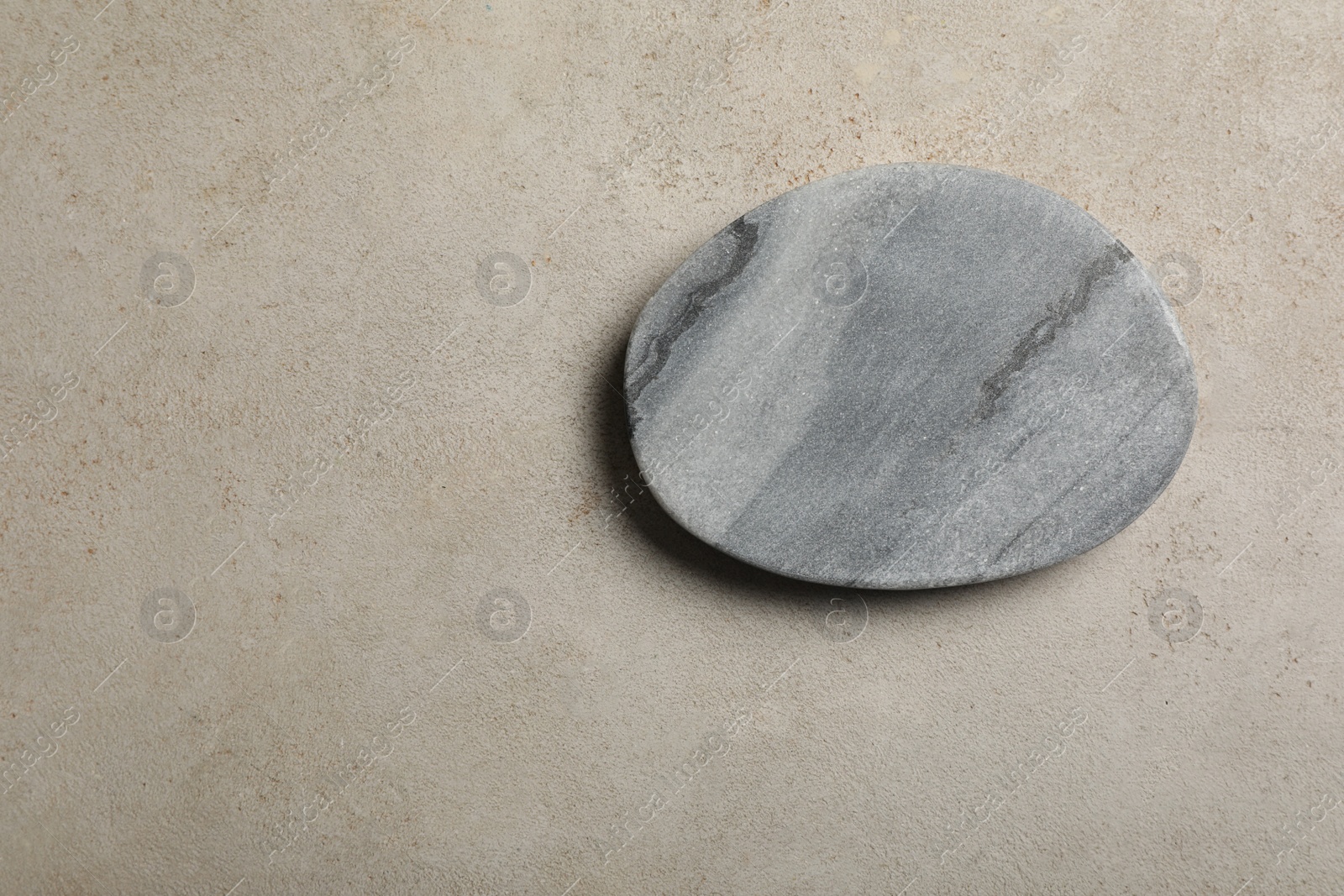 Photo of Stylish cup coaster on light grey table, top view. Space for text