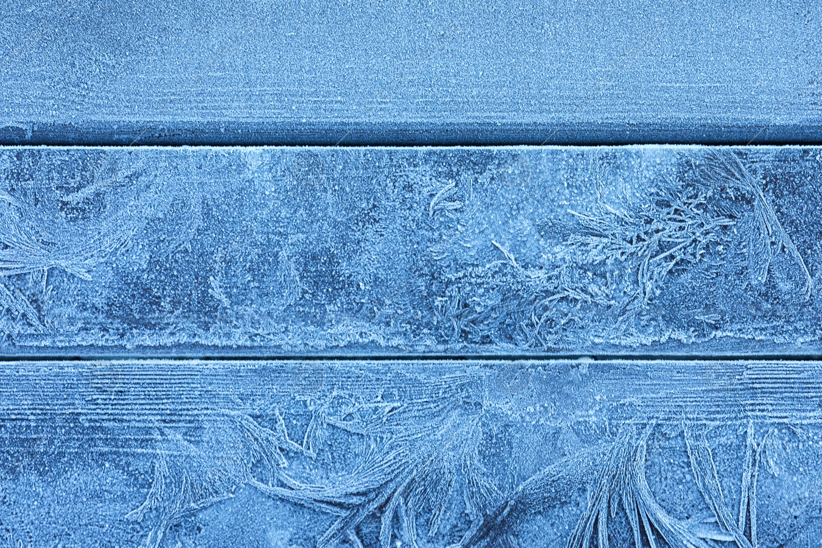 Photo of Beautiful hoarfrost on wooden background, top view