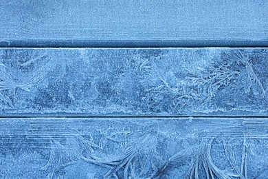 Beautiful hoarfrost on wooden background, top view