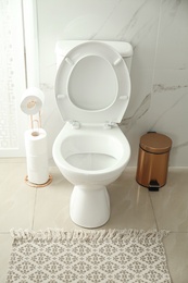 Photo of White toilet bowl in modern bathroom interior