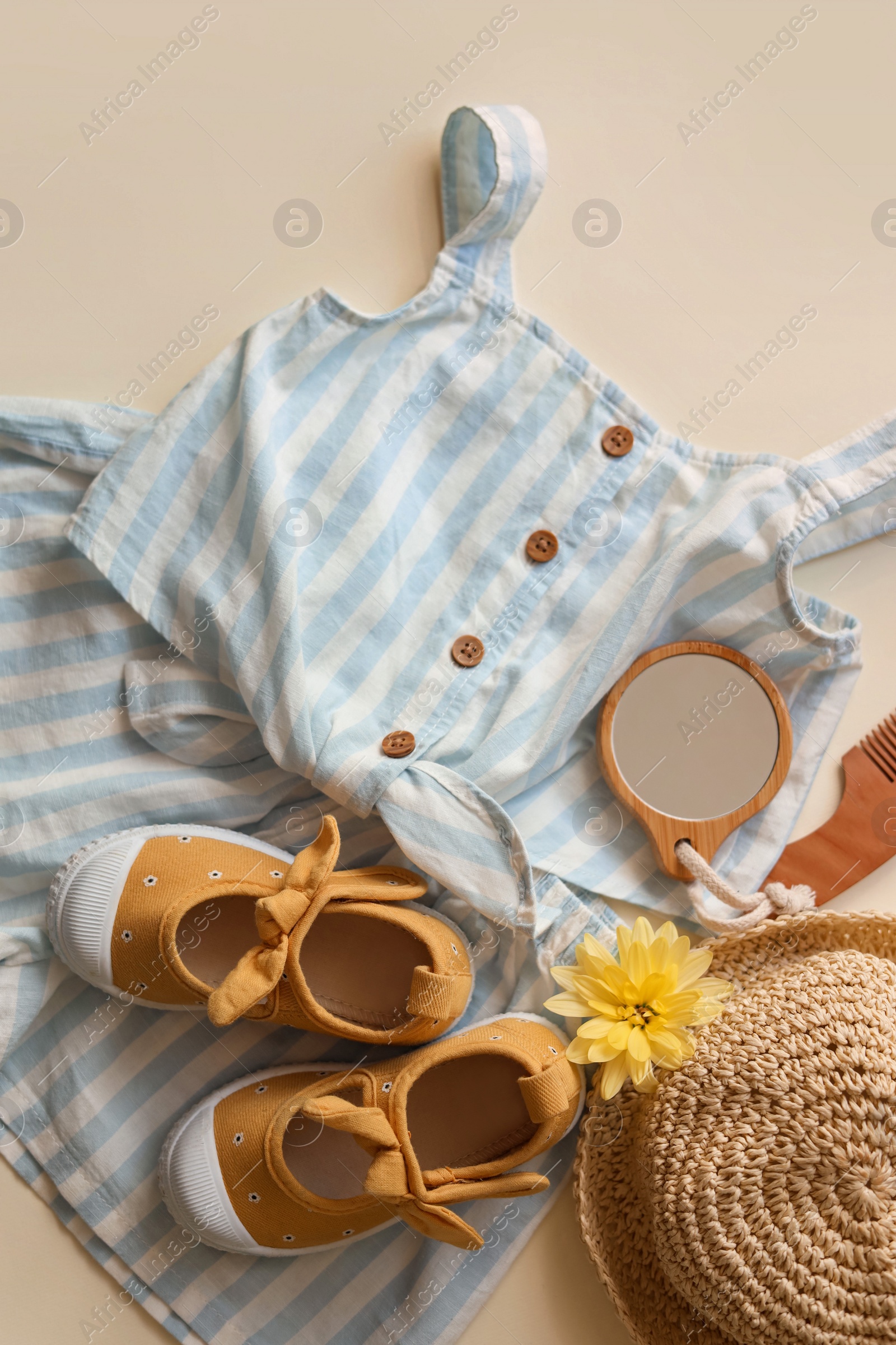 Photo of Stylish child clothes, shoes and accessories on beige background, flat lay