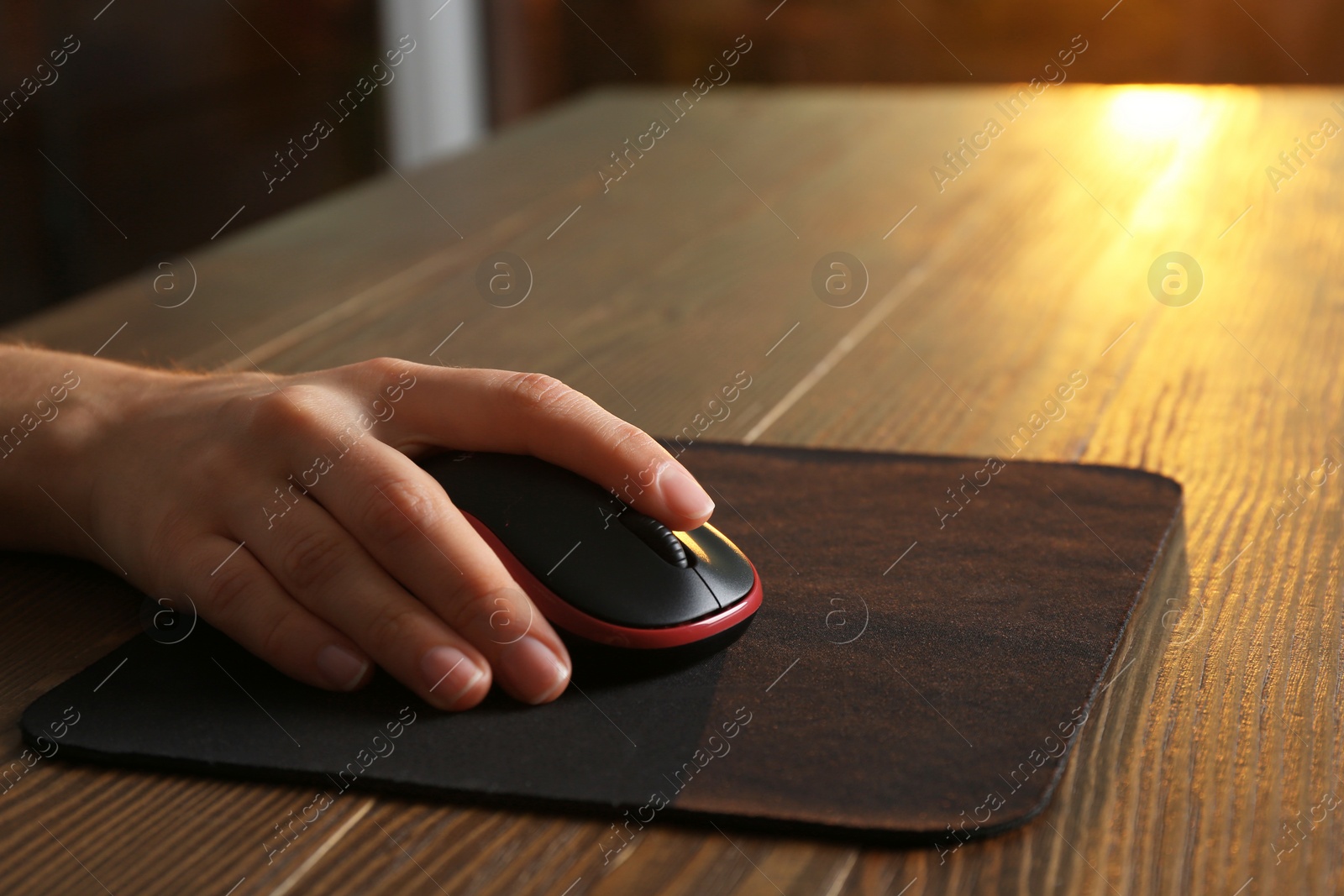 Photo of Woman using computer mouse at table, closeup. Space for text