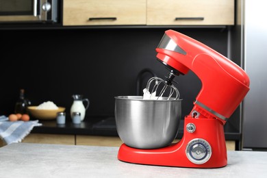 Photo of Modern stand mixer on table in kitchen. Home appliance