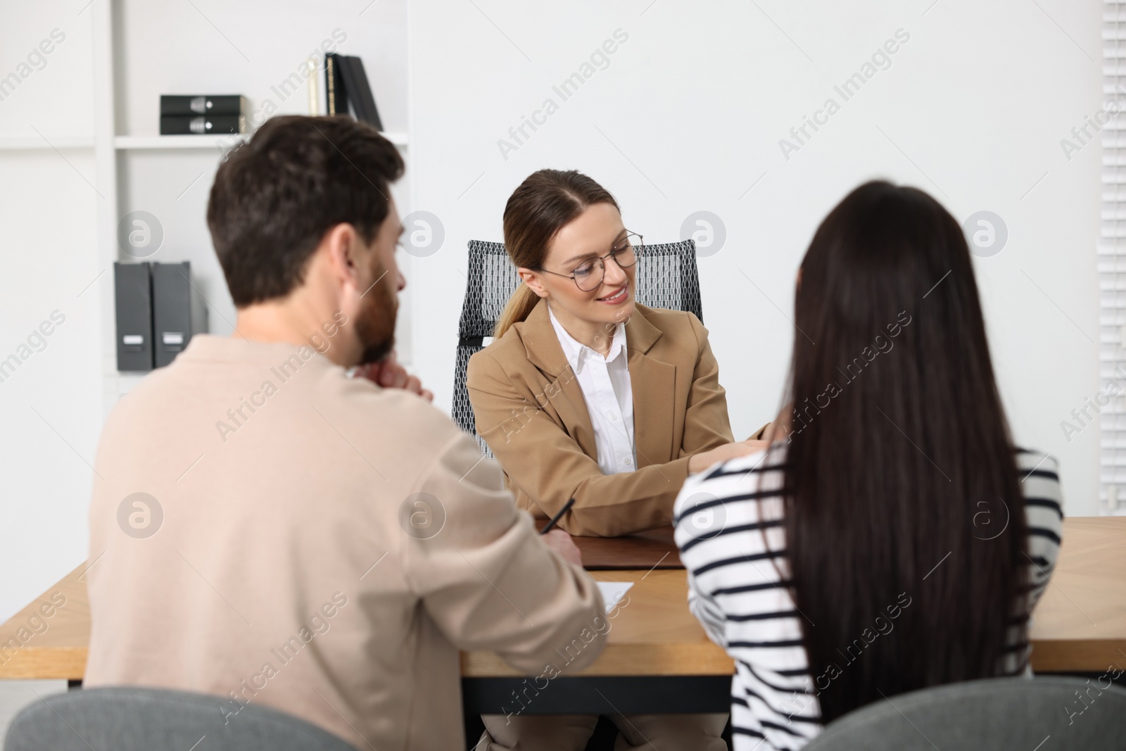 Photo of Couple having meeting with lawyer in office