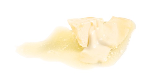 Photo of Piece of melting butter on white background