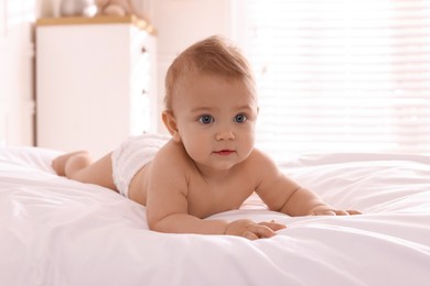 Photo of Cute little baby on bed at home