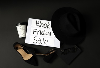Photo of Flat lay composition with women's shoes, hat and phrase Black Friday Sale on dark background