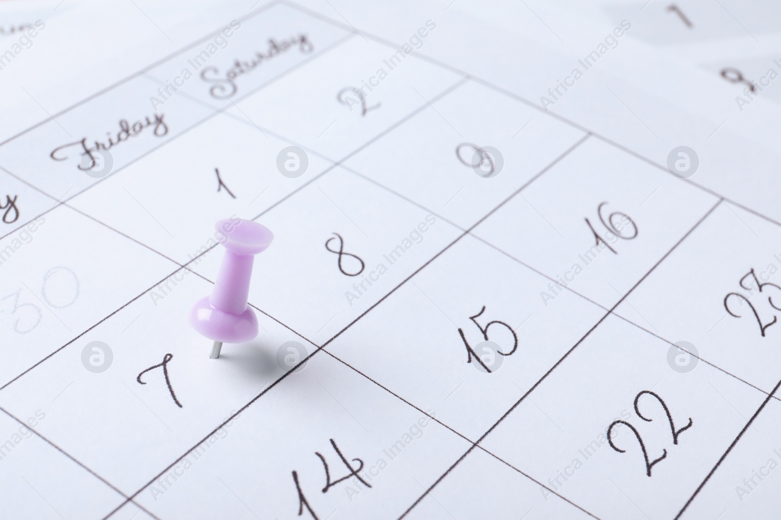 Photo of Calendar page marked with drawing pin, closeup