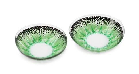 Photo of Two green contact lenses isolated on white